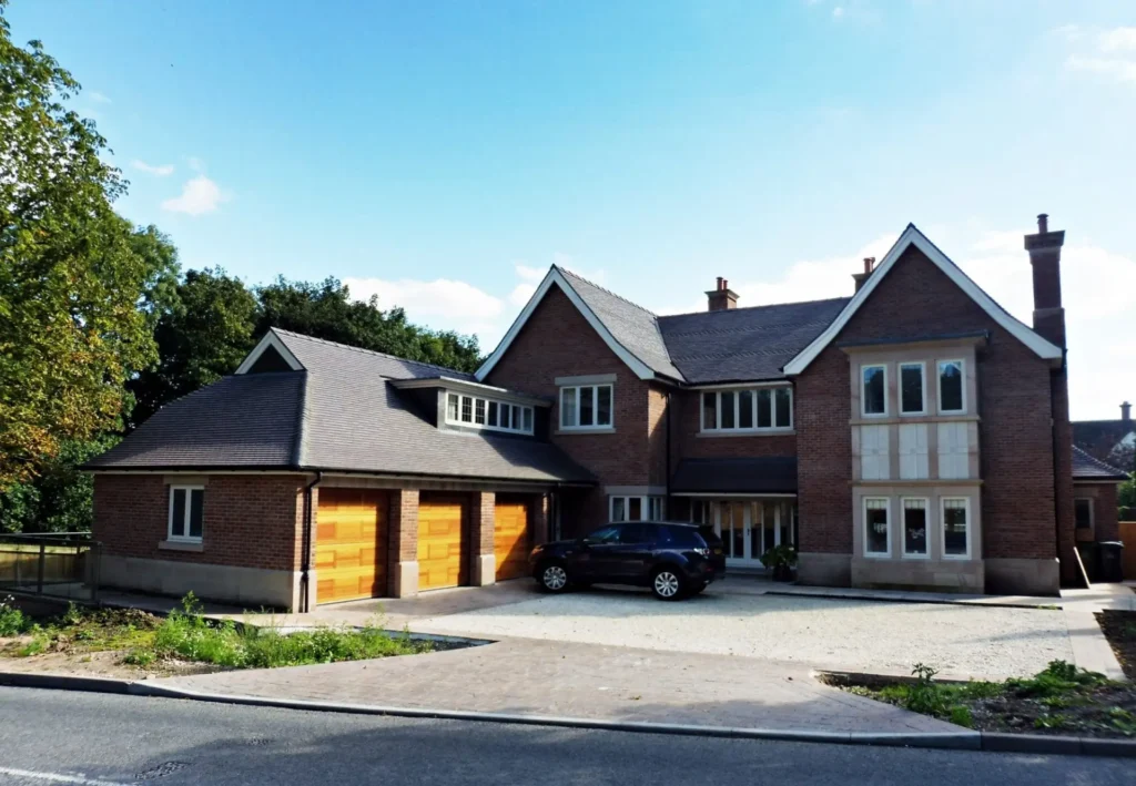Large new-build home in Quarndon featuring Gowercroft’s bespoke Accoya windows, triple timber garage doors, and custom detailing for a traditional yet high-performance finish.