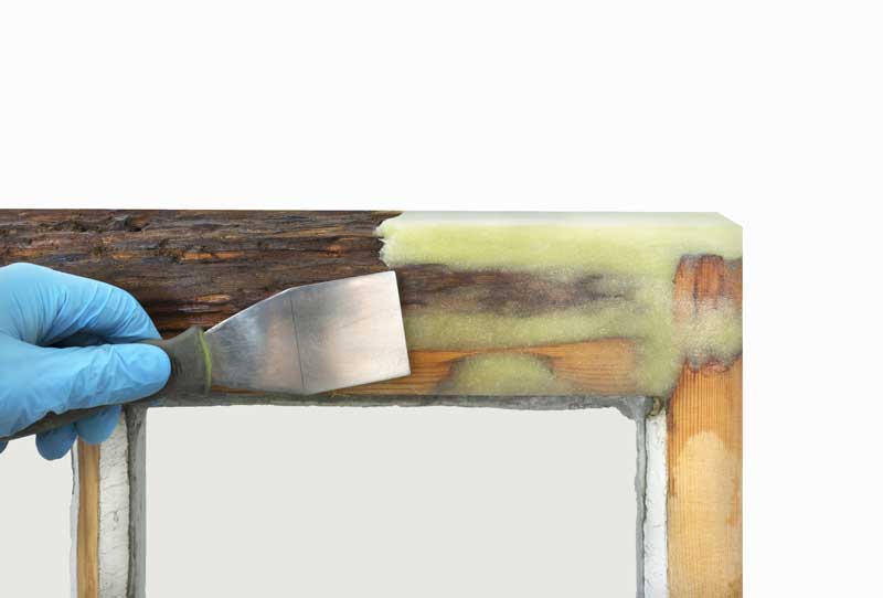 Close up shot of restoring a heritage window with filler